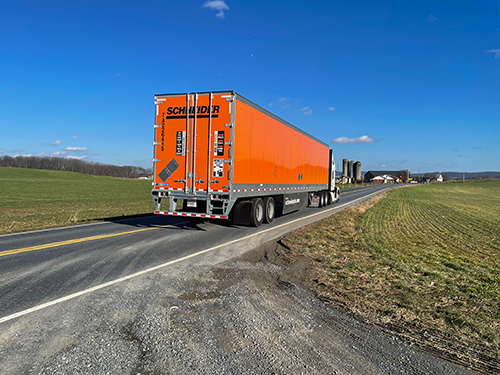 big orange truck on road